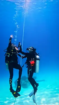 Instructor is teaching Control Emergency Swimming Ascent in the ocean
